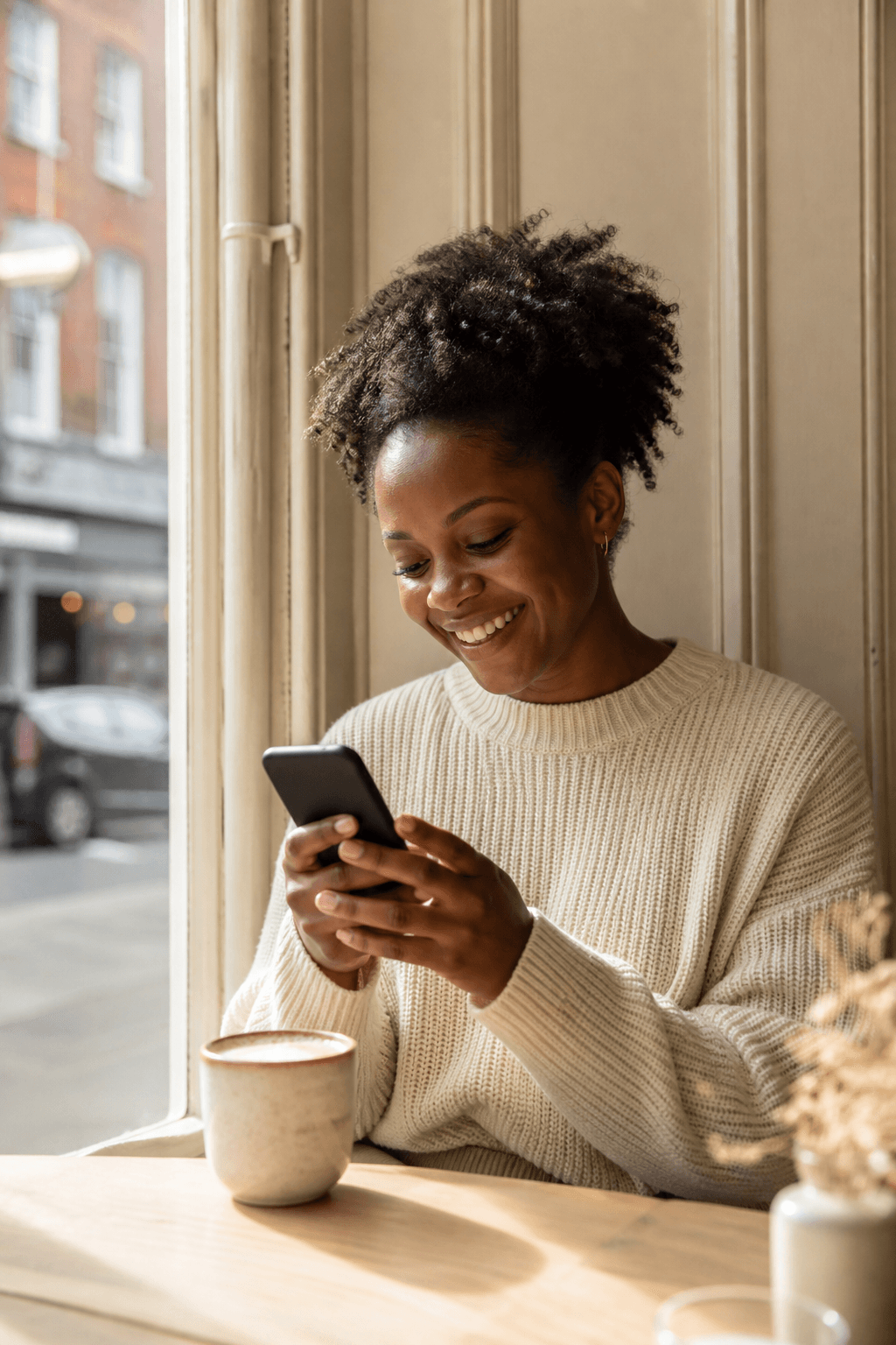Someone checking reviews on a phone in a cafe